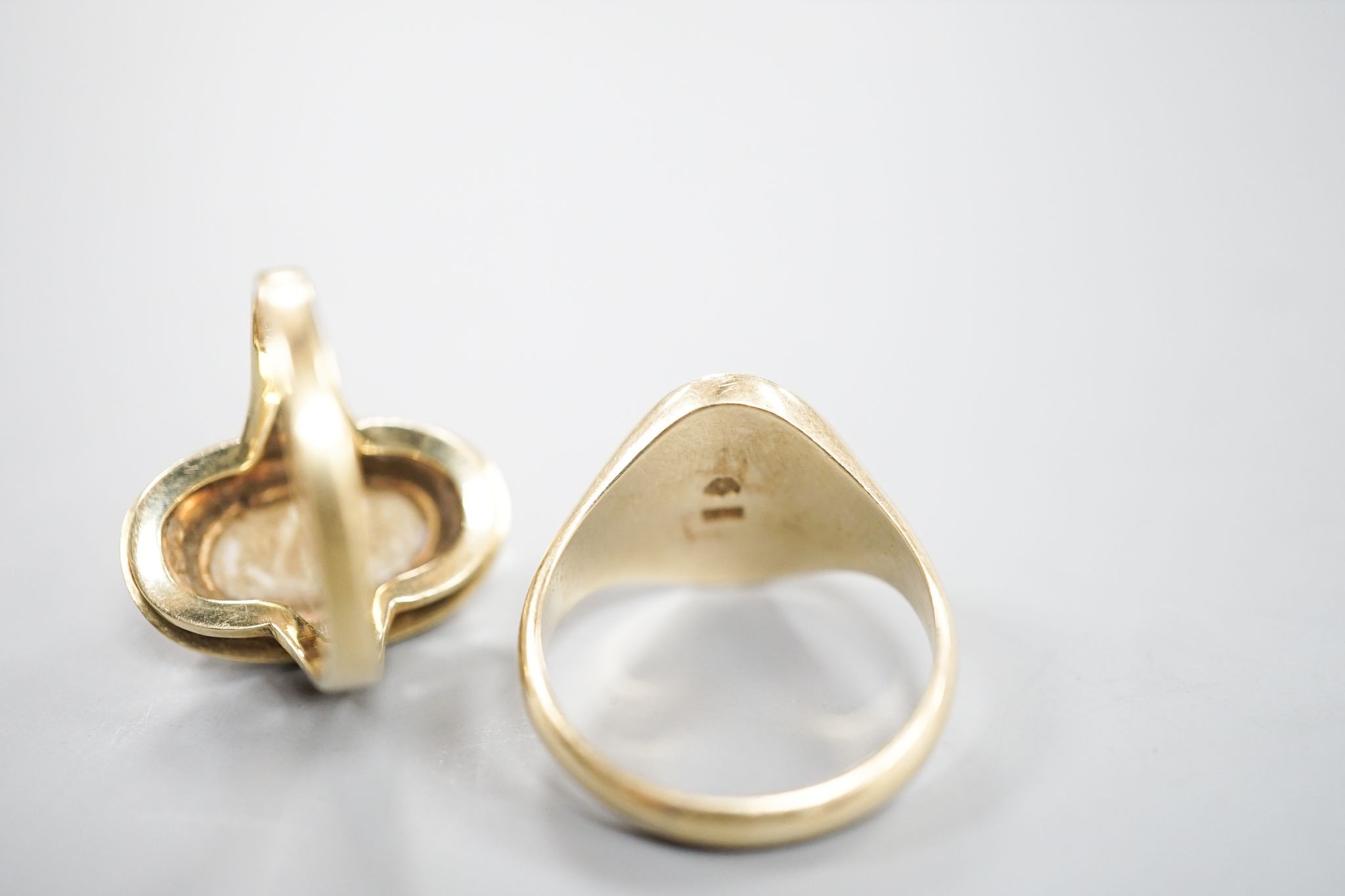 A 585 yellow metal signet ring, with engraved monogram, size O/P and a 585 and white metal and white metal oval dress ring, size O, gross weight 12.6 grams.